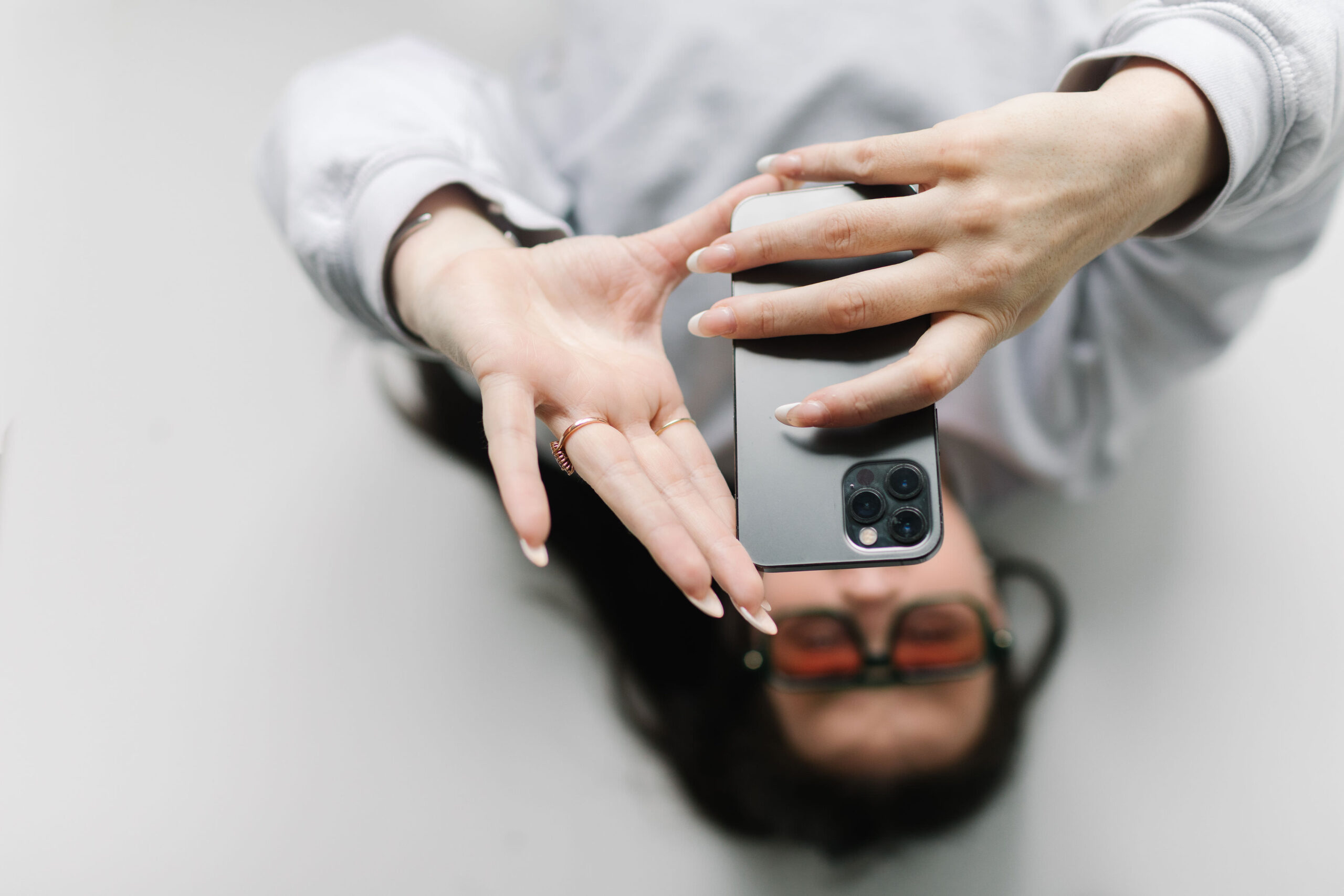 Woman taking a photo with her iPhone — turning customer moments into marketing content for small business